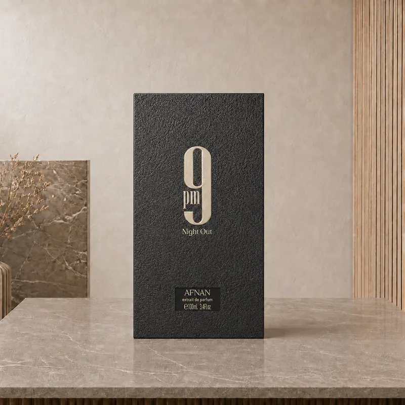 Front of the black Afnan 9PM Night Out Extrait de Parfum 100ml presentation box in a beige studio.