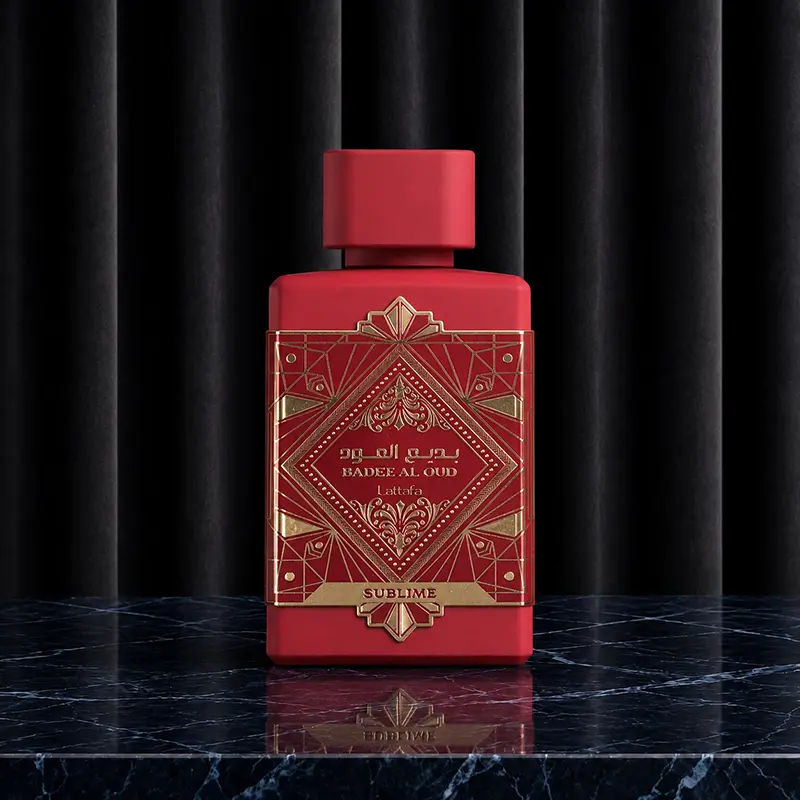Straight front shot of the geometric crimson red perfume bottle on a reflective black marble countertop.