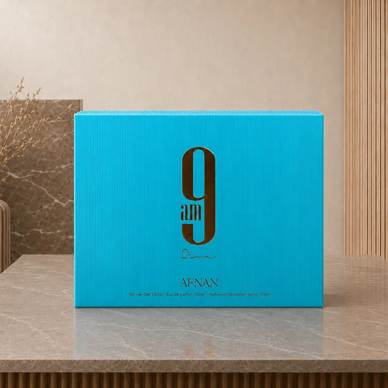 Blue Afnan 9AM Dive gift-set box shown upright on a stone studio surface.