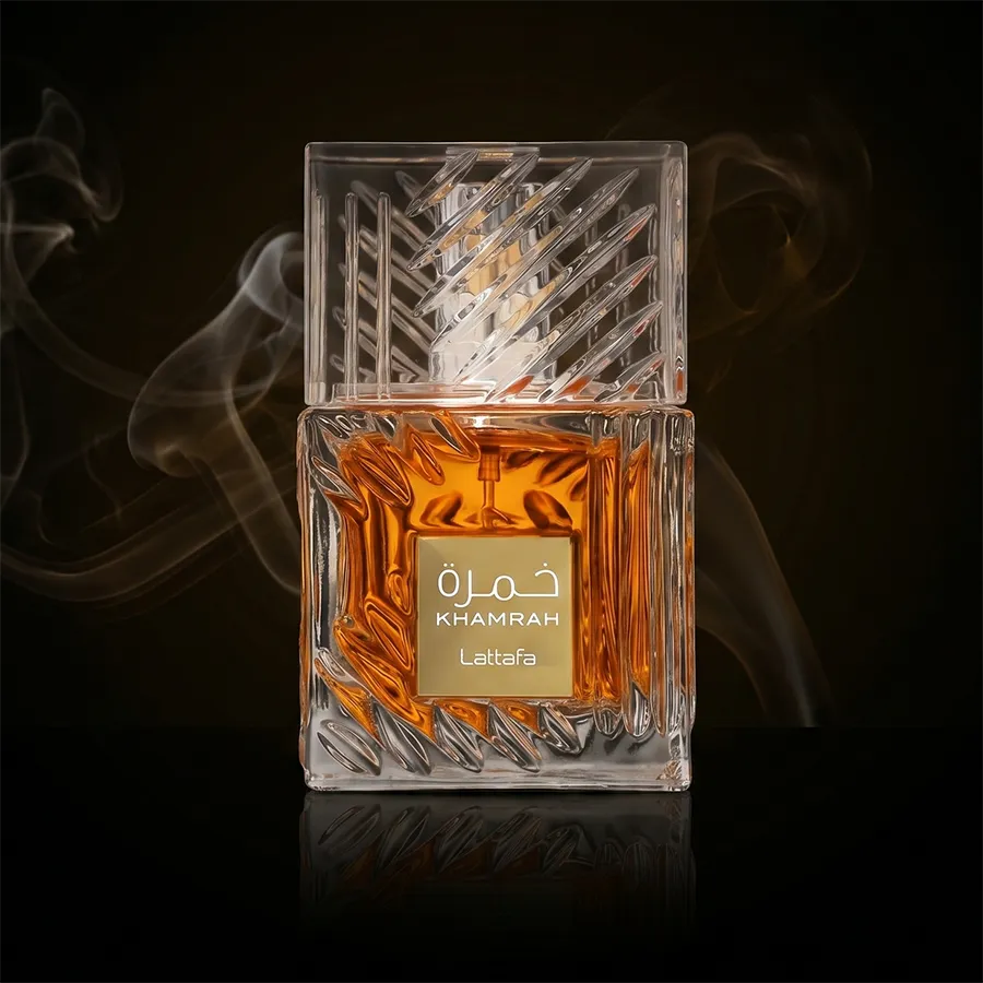 Lattafa Khamrah unisex perfume in a luxury crystal glass bottle with amber liquid and warm spicy notes.