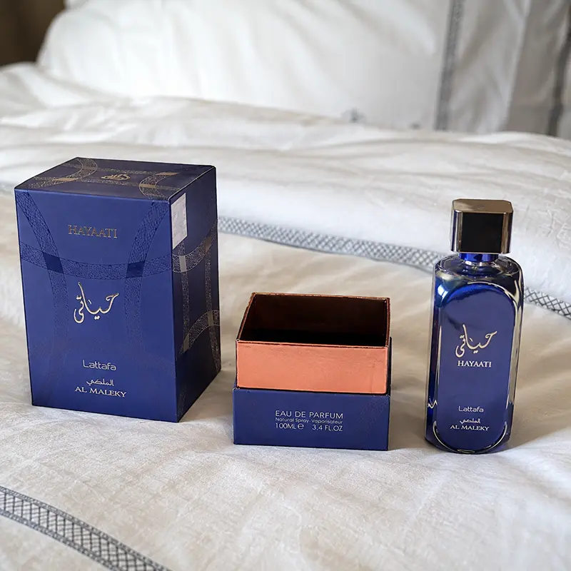 A relaxed bedroom atmosphere showcasing the perfume, box and unboxing experience