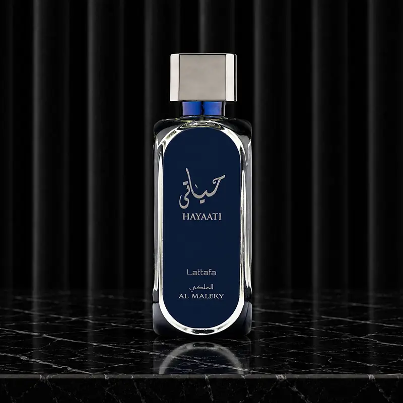 Transparent glass bottle with metallic cap highlighting the refined design elements