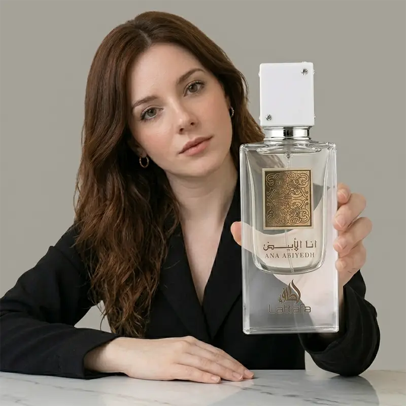 Model holding the 60ml Lattafa Ana Abiyedh bottle to showcase the product size and luxury aesthetic.