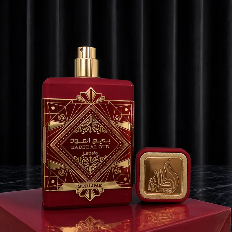 High-angle closeup of the golden spray nozzle with the square red and gold cap standing next to the base.