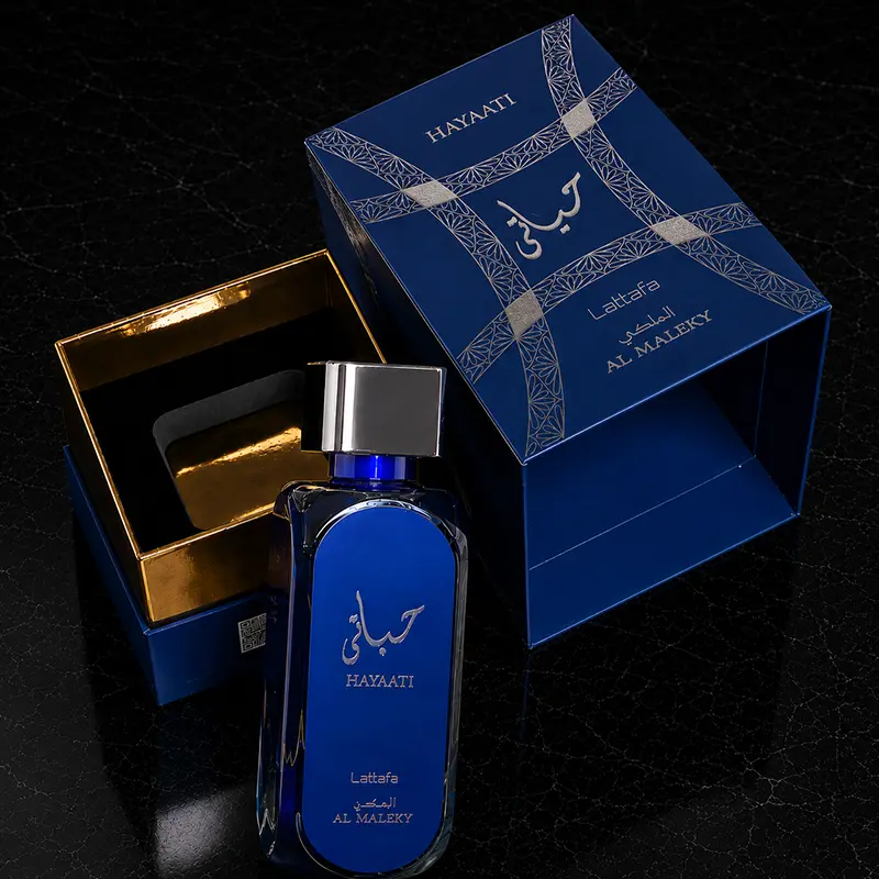 Open box perspective revealing the inner golden finish and fragrance presentation details