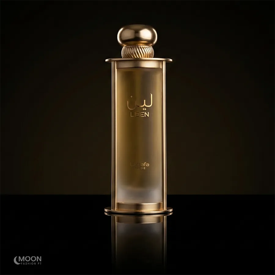 Elegant gold Lattafa Leen perfume bottle for men and women 100ml on a reflective dark surface.