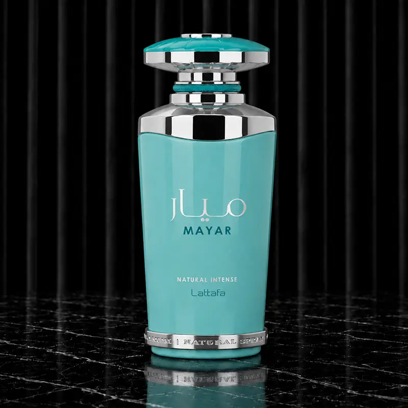 Lattafa Mayar Natural Intense bottle centred against black drapery on a veined stone surface