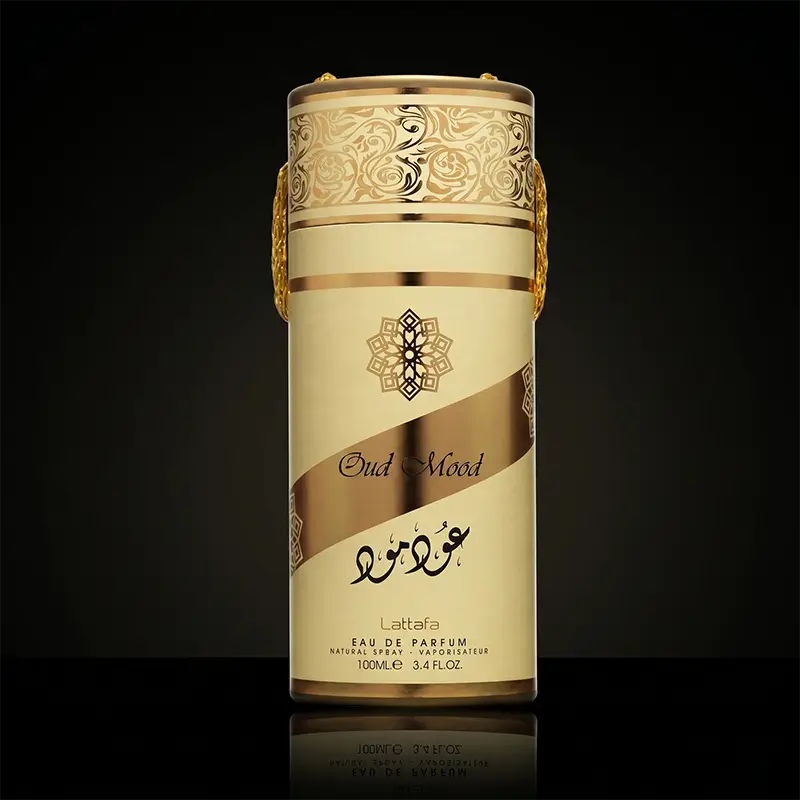 Lattafa Oud Mood unisex perfume bottle and gold cylinder packaging box featuring oriental woody notes.