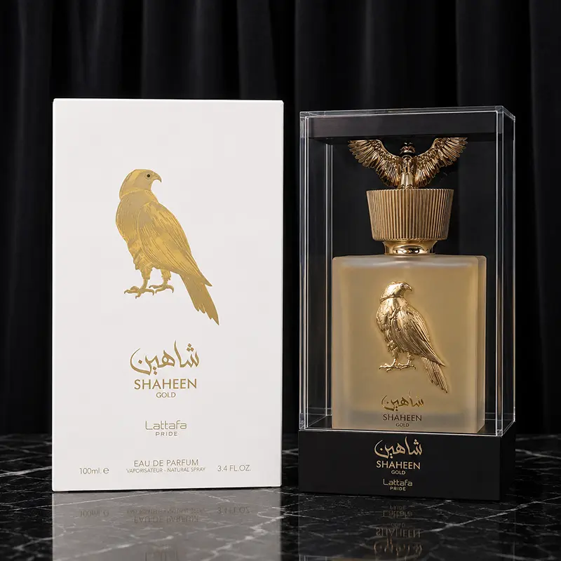 Shaheen Gold bottle inside clear display case beside the white outer box