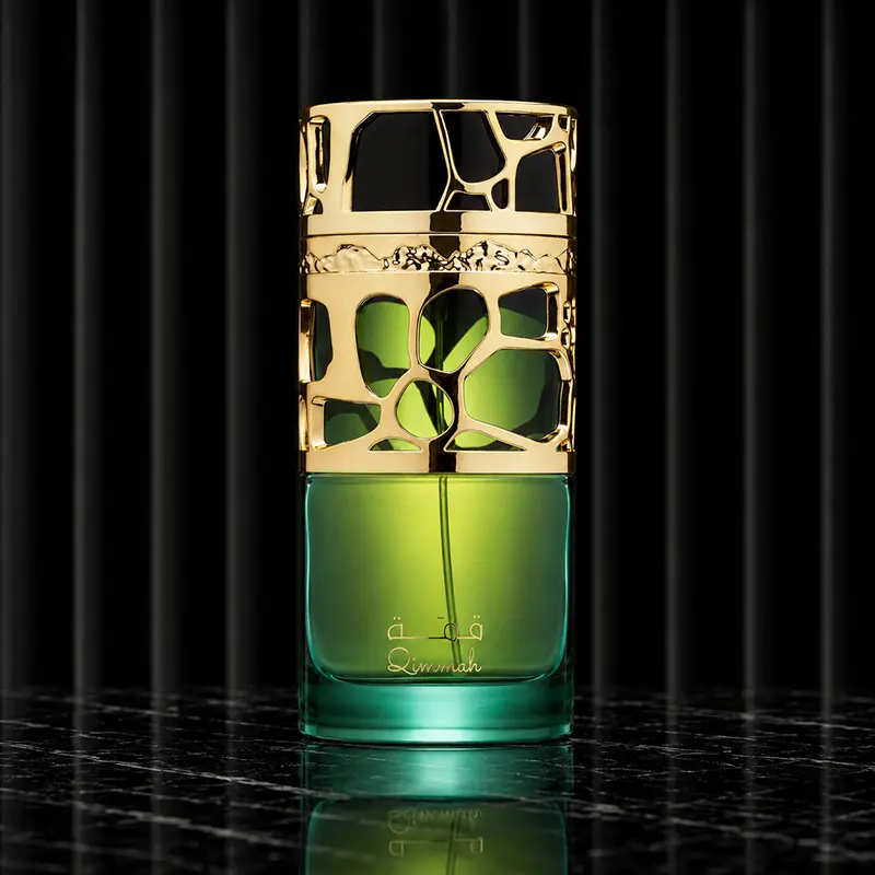Green and gold Qimmah For Women bottle shown from the front without the cap