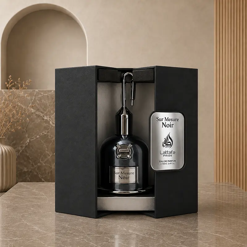 Sur Mesure Noir bottle displayed inside an open black case with a silver branded panel.