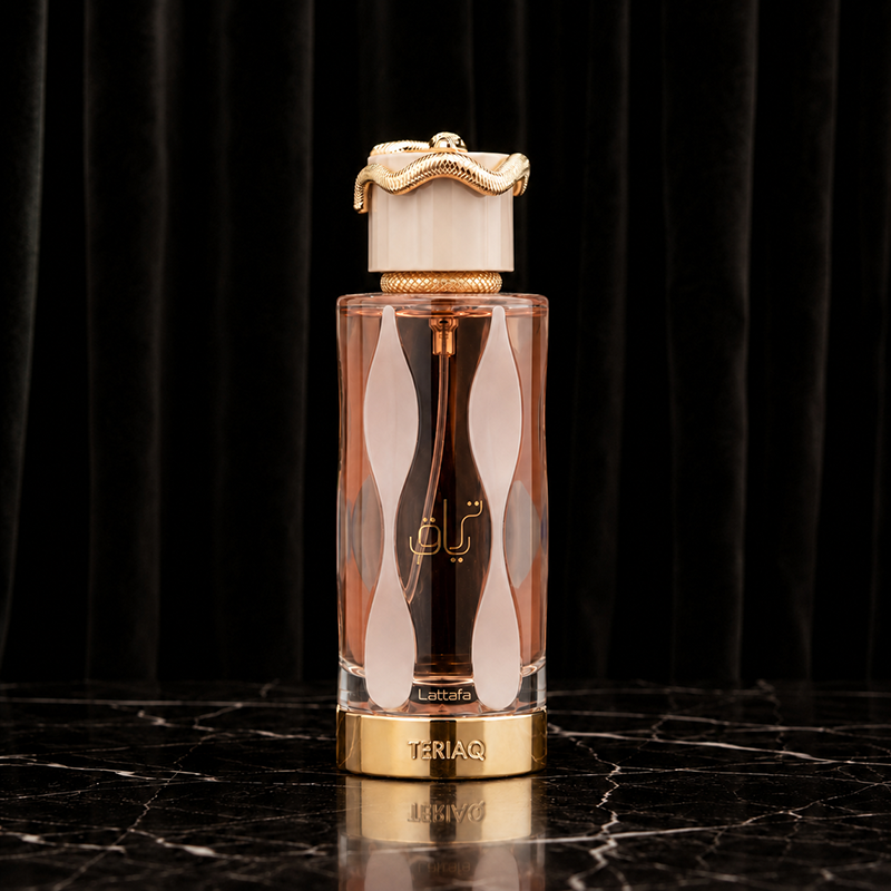 Front studio shot of the Teriaq bottle with peach liquid, gold base and serpent cap