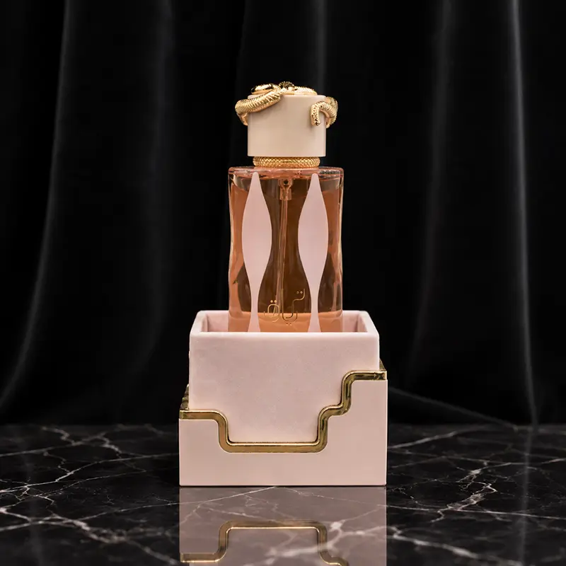 Teriaq bottle standing inside its plain blush inner box with metallic gold trim