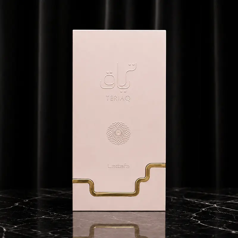 Embossed Teriaq box front with blush pink finish and stepped metallic gold border