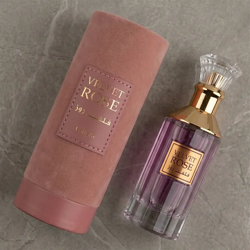 Detailed angled view of the Lattafa Velvet Rose bottle alongside its premium pink suede cylindrical packaging.