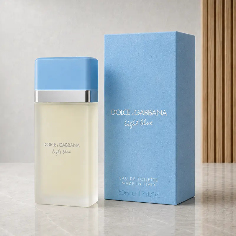 Dolce&Gabbana Light Blue bottle beside its blue box in a neutral studio