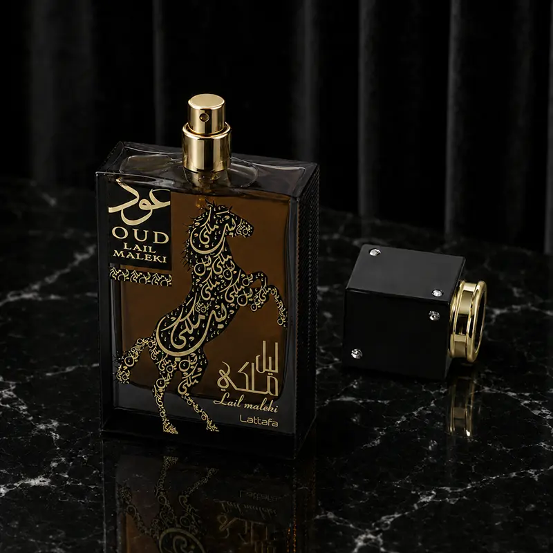 Bottle detail; spray nozzle, removed black cap, reflective marble surface