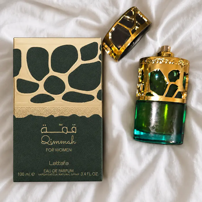 Qimmah For Women bottle and box arranged on soft white fabric